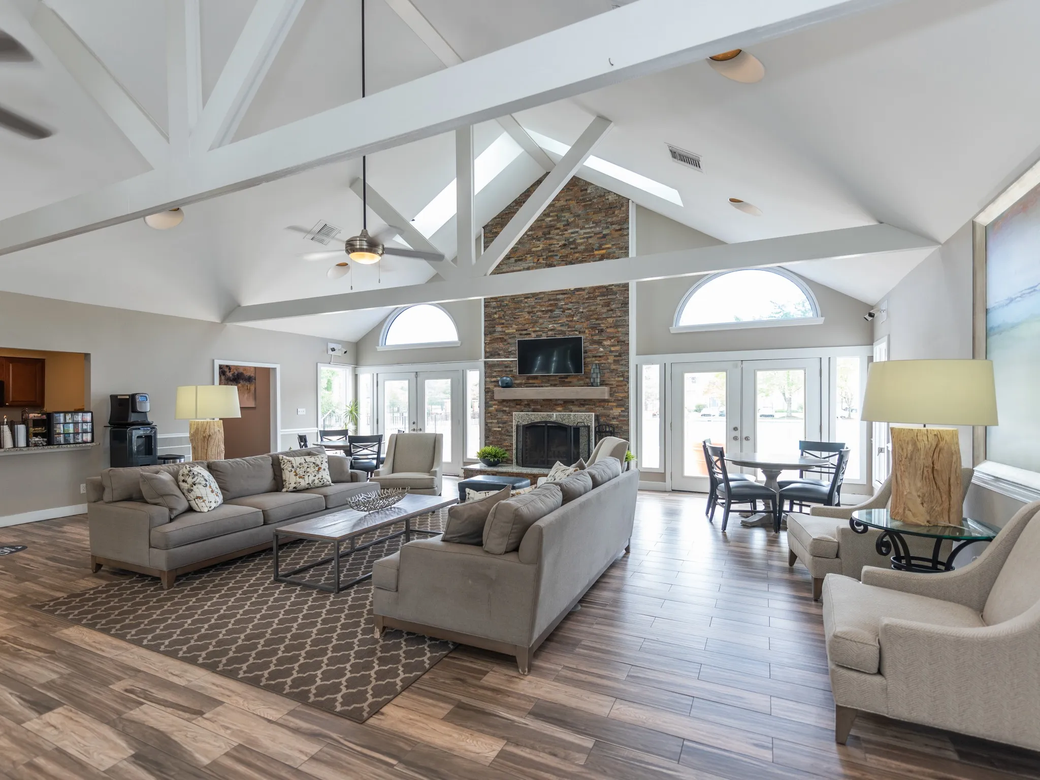 Resident lounge at our apartments for rent in Leesburg, VA, featuring wood grain floor paneling and a fireplace.