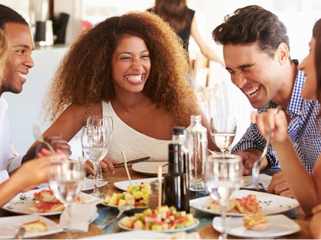 Friends laughing during meal