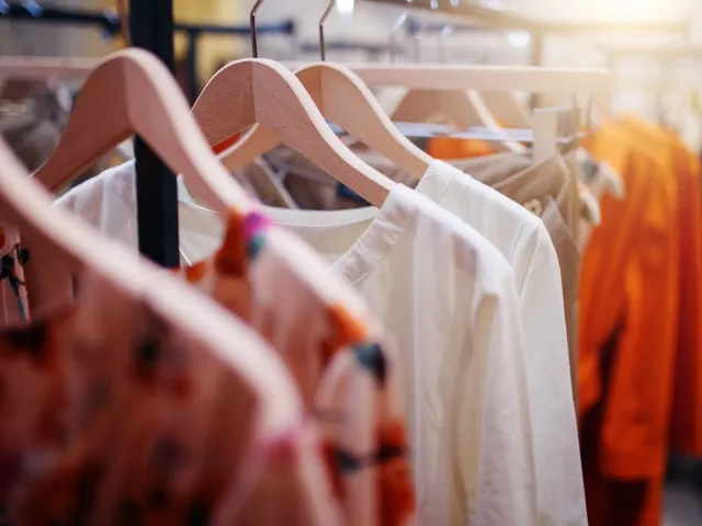 clothes hanging on a rack in a store