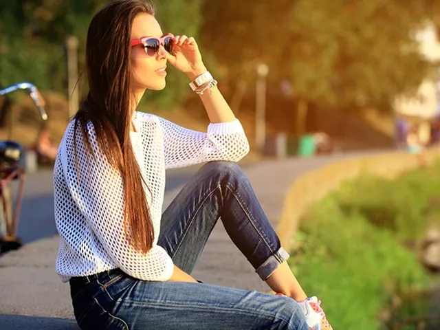 girl sitting down on a concrete wall