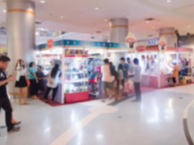 Bright and bustling indoor shopping area with colorful kiosks and people enjoying a vibrant market atmosphere.