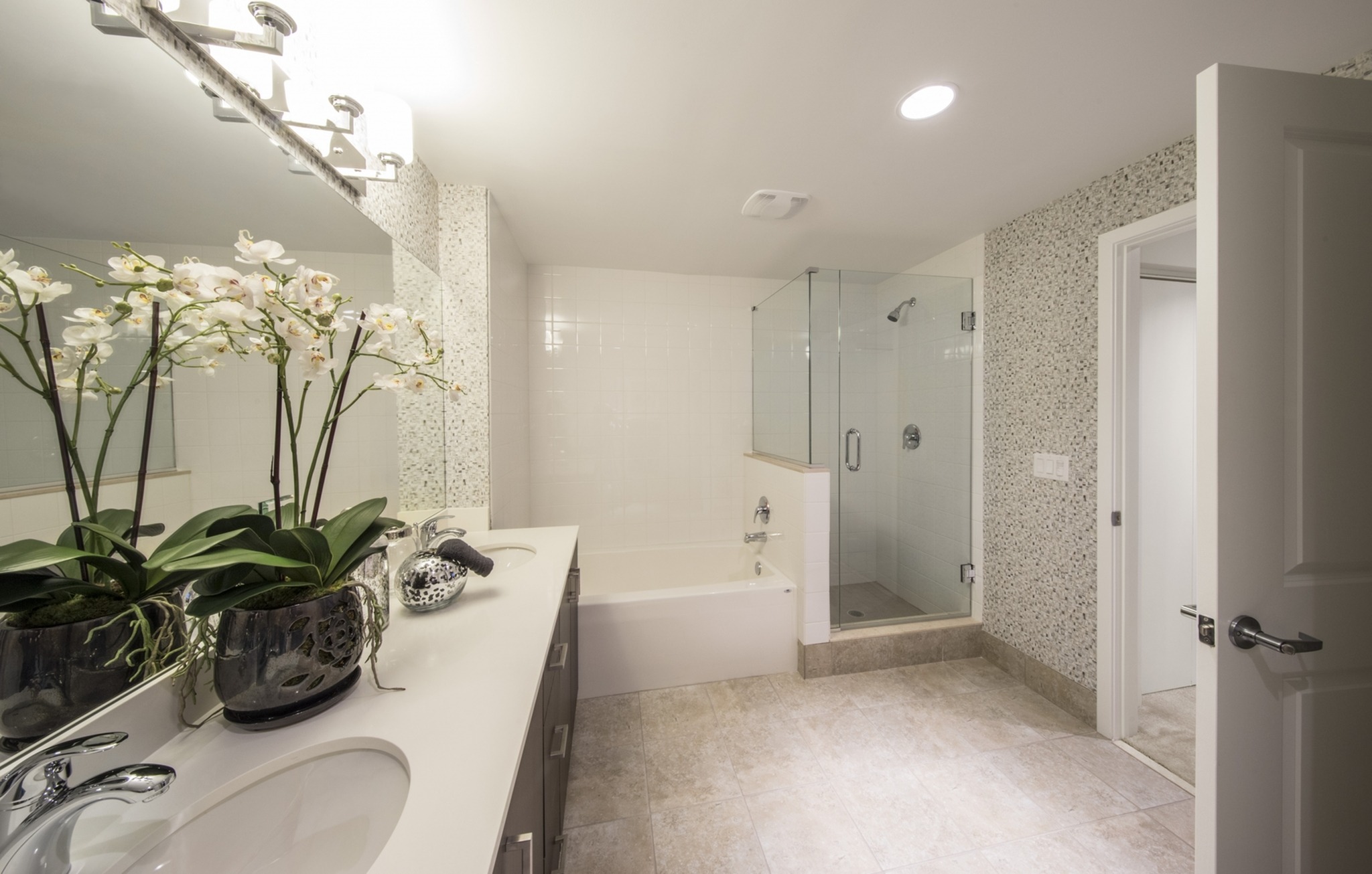 Spacious baths with frameless glass-enclosure showers