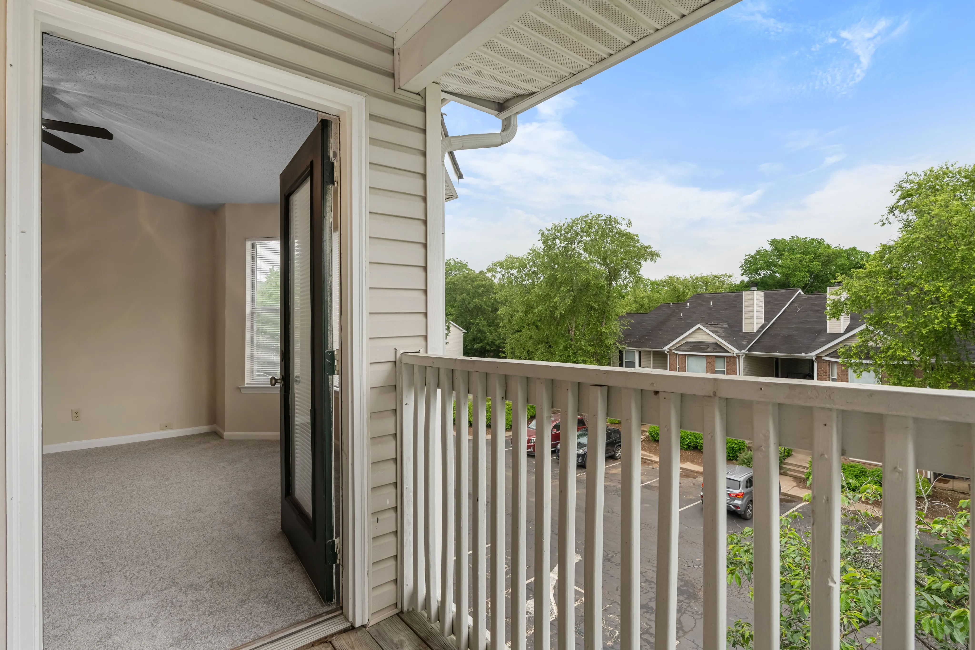 Inviting open patio view showcasing a serene neighborhood and lush greenery, perfect for relaxation.
