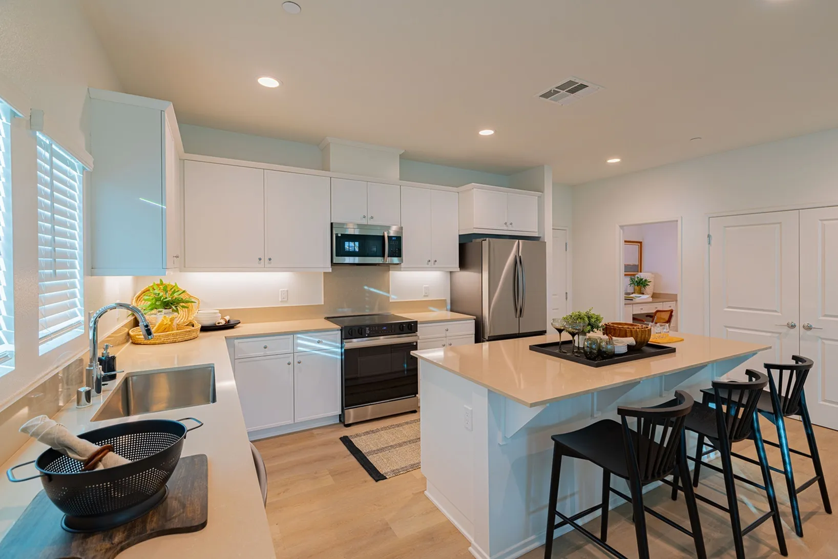 Modern kitchen with sleek stainless steel appliances, elegant countertops, and ample lighting for a bright, inviting atmosphere.