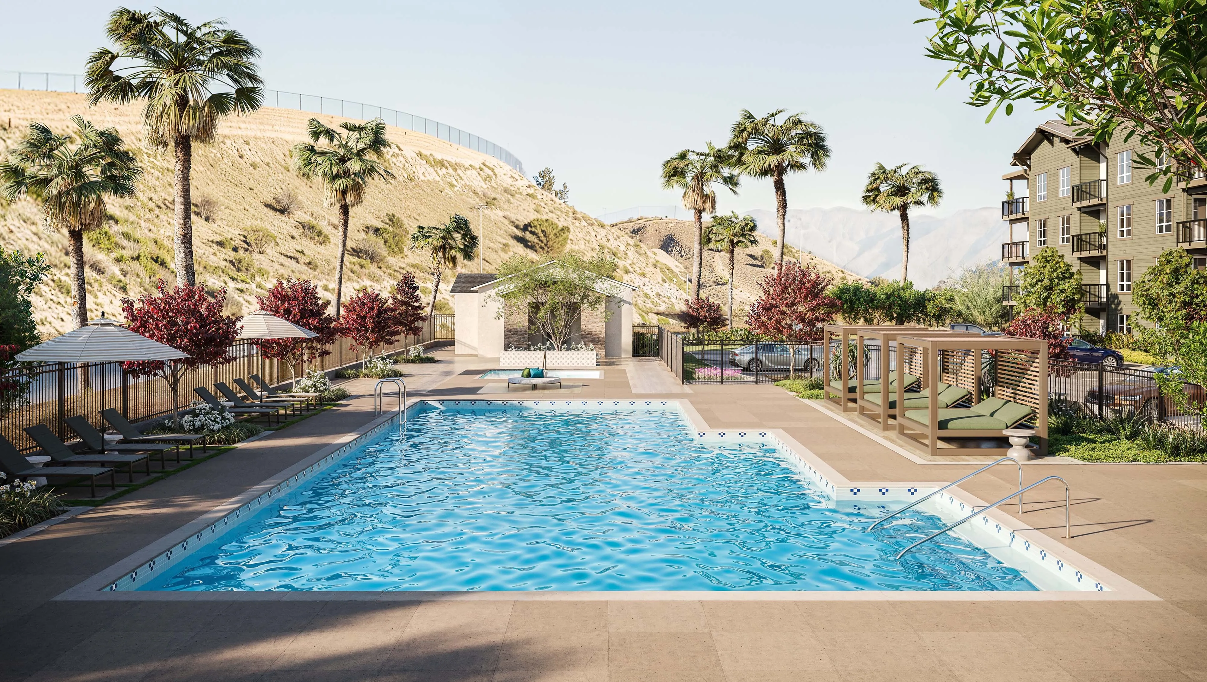 Outdoor pool area with spa and lounge seating, offering a serene escape with stunning hillside views.