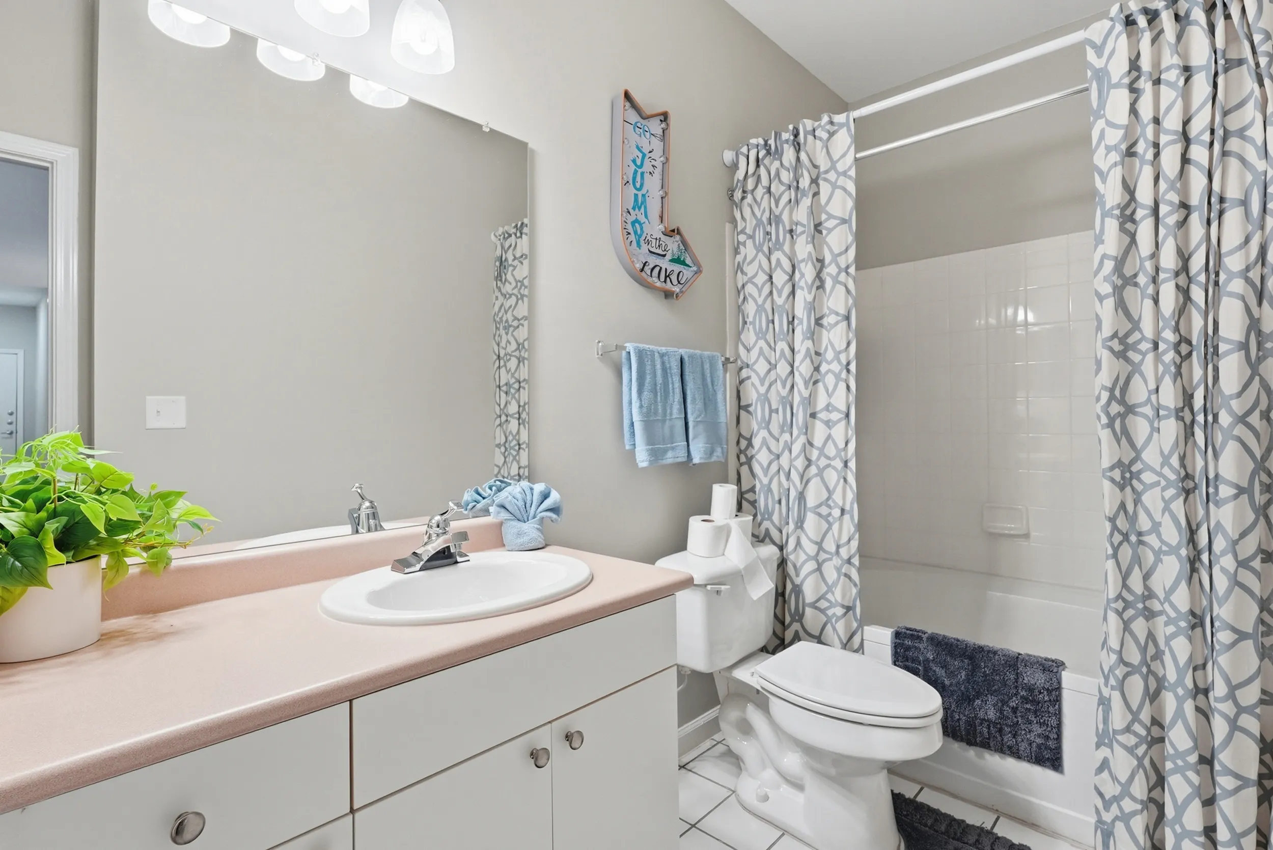 Contemporary bathroom with modern fixtures, elegant patterned shower curtain, and inviting atmosphere.