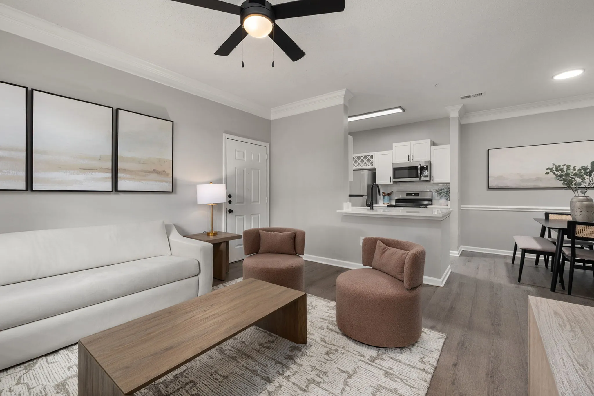 Beautifully designed open-concept living area featuring modern furnishings, a sleek kitchen, and elegant decor accents.