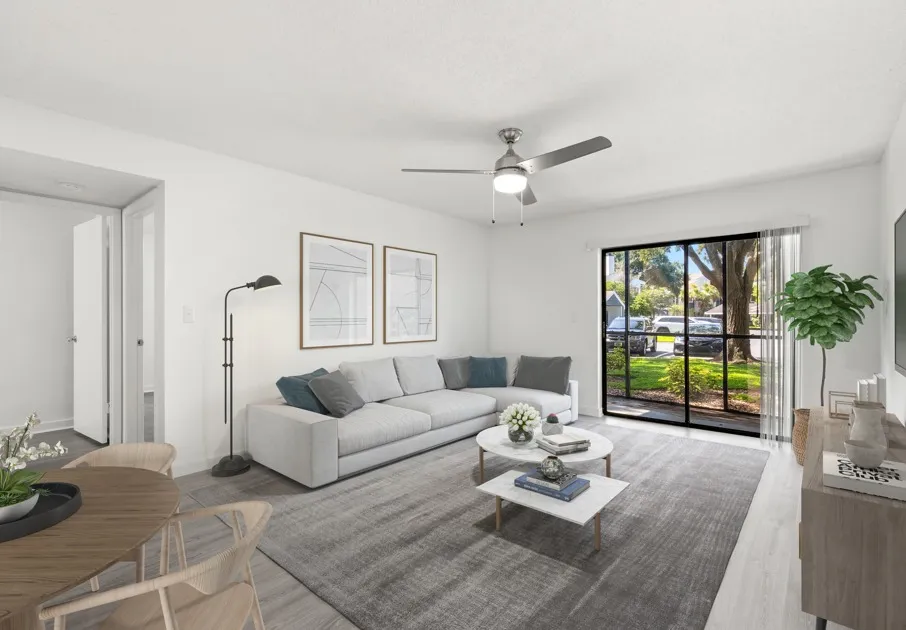 Model living room at Avana Lakeview Apartments in Clearwater, FL, featuring wood grain flooring and grey couches.