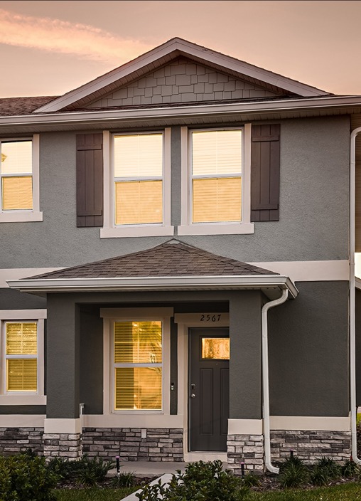 Exterior view of townhome with a beautiful sunset for rent in Apopka, Florida.