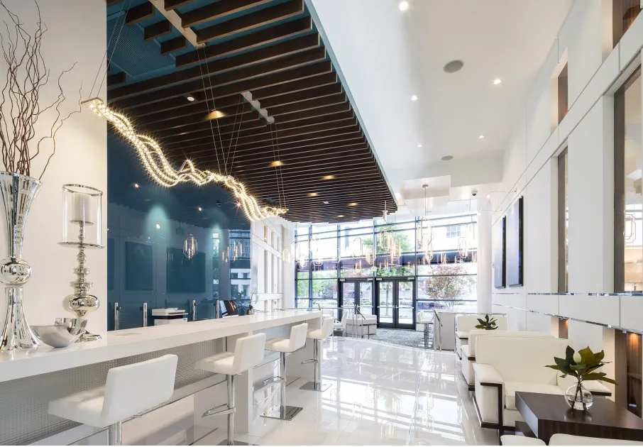 Common lounge and dining area at our apartments in Atlanta, GA, featuring ample seating, colorful decor, and hanging lights.