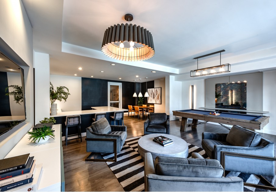 Resident lounge at our apartments for rent in Herndon, VA, featuring couches, counter seating, and billiards table.