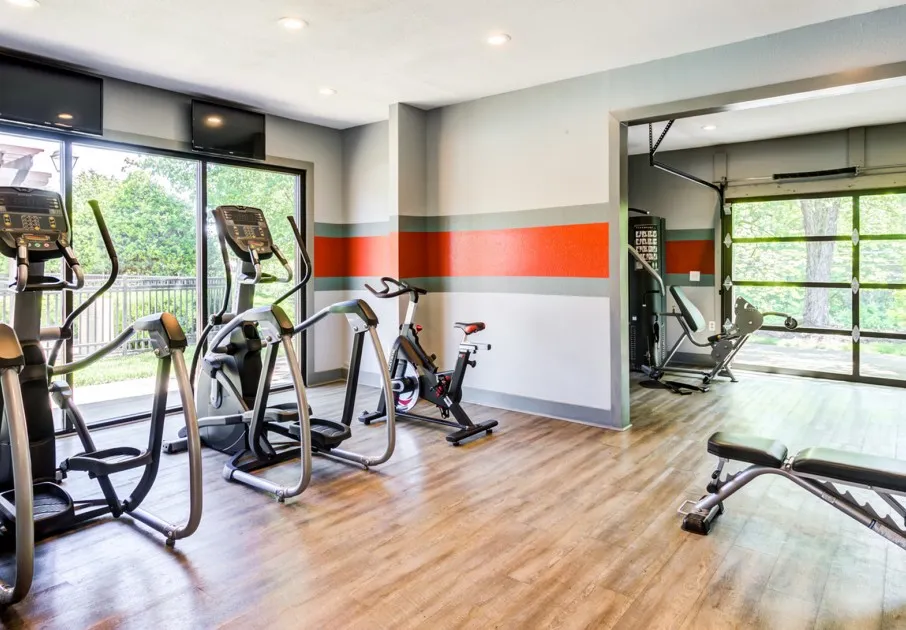 Fitness center at our apartments for rent in Antioch, TN, featuring wood grain floor paneling and exercise bikes.