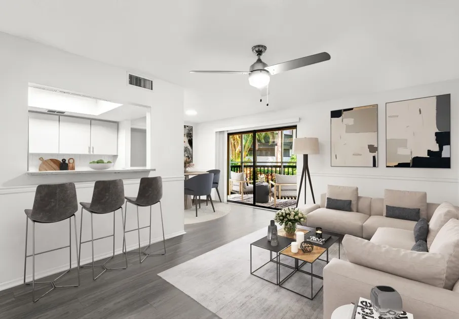 Model living room at our apartments for rent in Clearwater, FL, featuring wood grain floor paneling and modern decor.