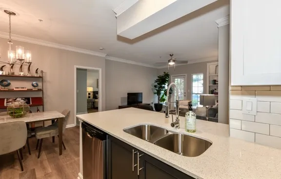 Model kitchen featuring a view of the dining room at Avana Cheshire Bridge Apartments for rent in Atlanta, GA.