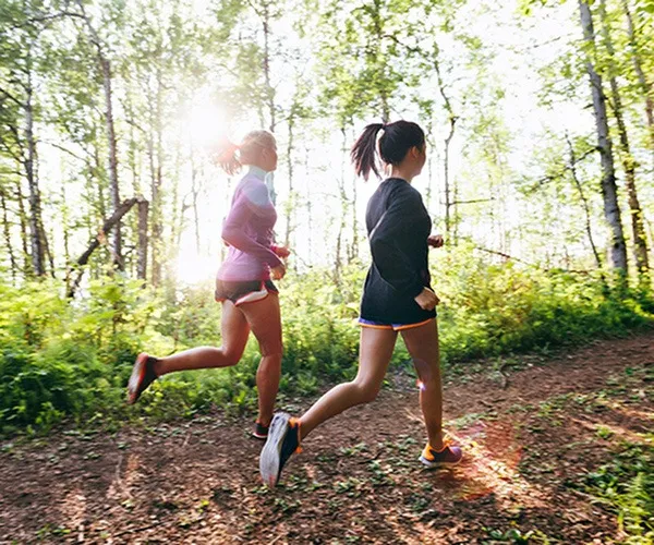 women running on a trail outside