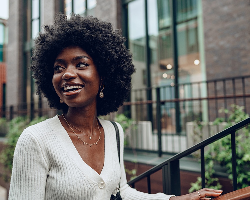 woman smiling while walking outside