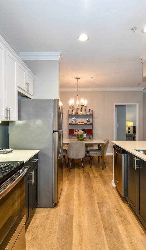 Model kitchen featuring white counter tops at Avana Cheshire Bridge Apartments for rent in Atlanta, GA.