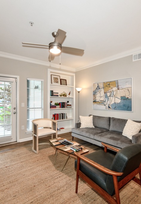Model living room featuring wood grain flooring at Avana Cheshire Bridge Apartments for rent in Atlanta, GA.