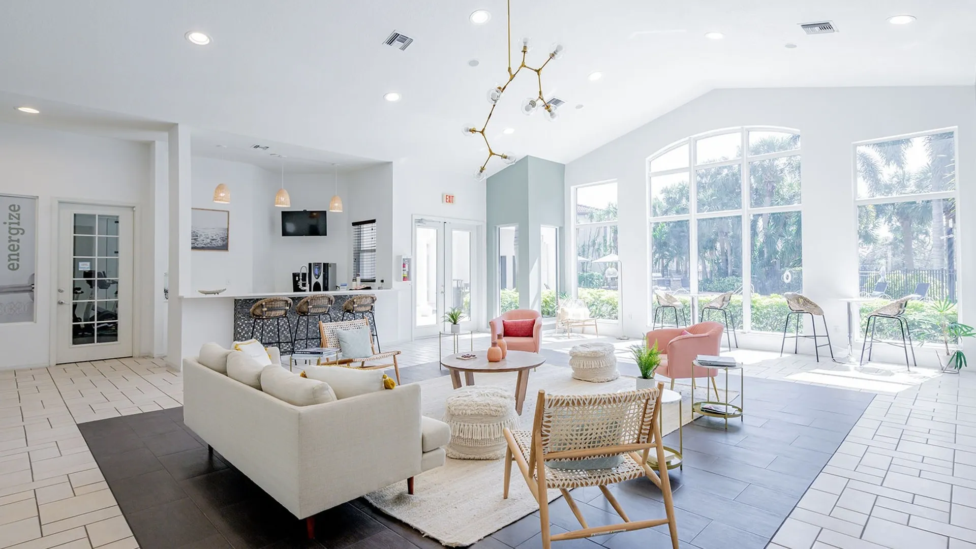 Model living room at our apartments for rent in West Palm Beach, FL, featuring an open floor plan and large windows.