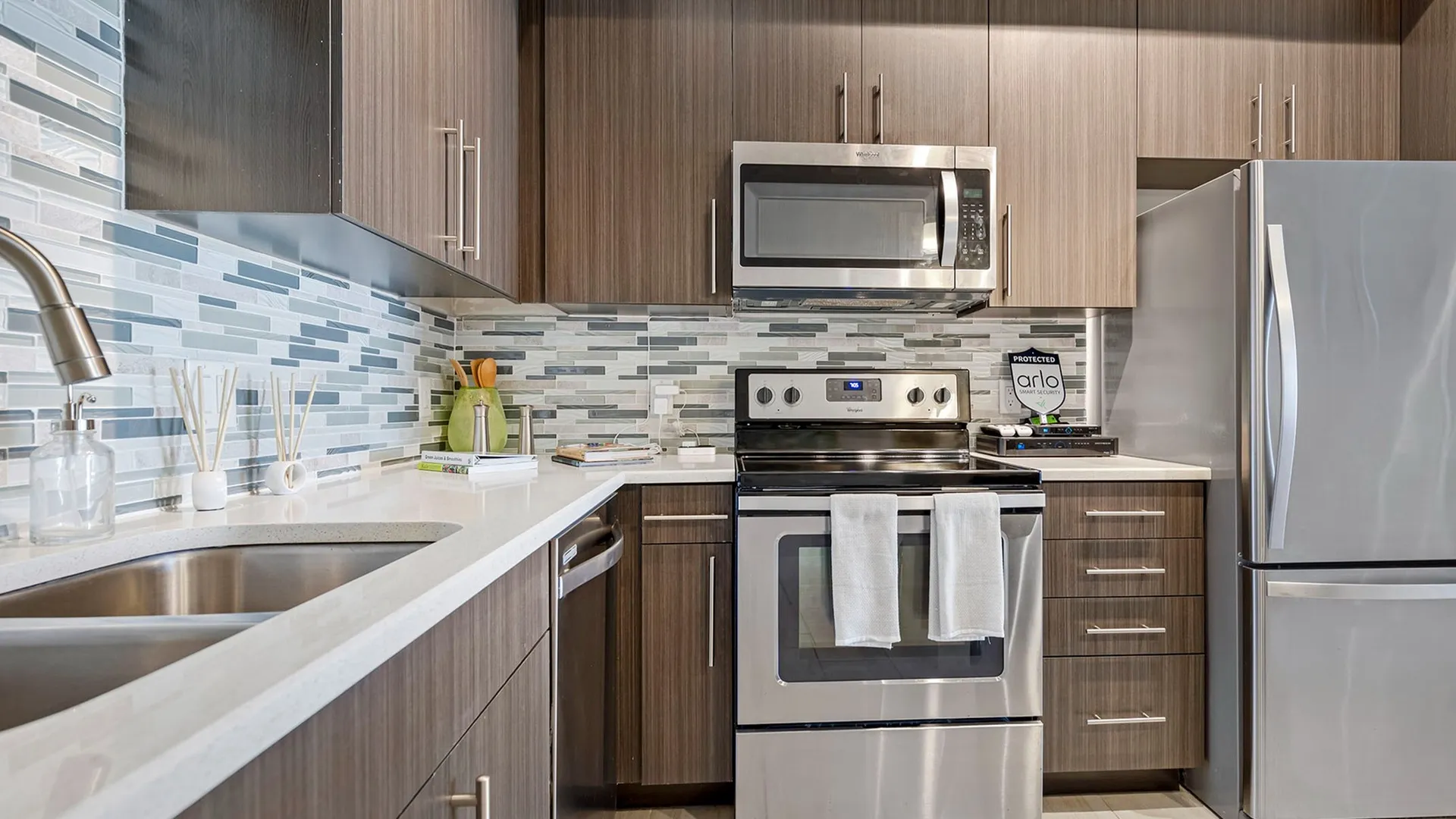Model kitchen at our apartments for rent in Boca Raton, FL, featuring an oven, refrigerator, and microwave.