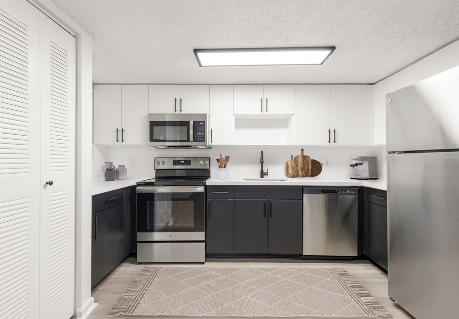 Kitchen area featuring plank flooring and updated stainless steel appliances