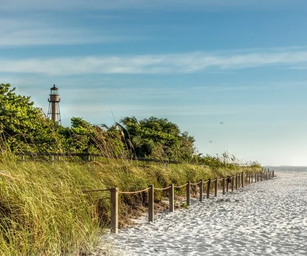 The shoreline near Marlowe Naples apartments for rent in Naples, FL, featuring a view of the lighthouse and beach.