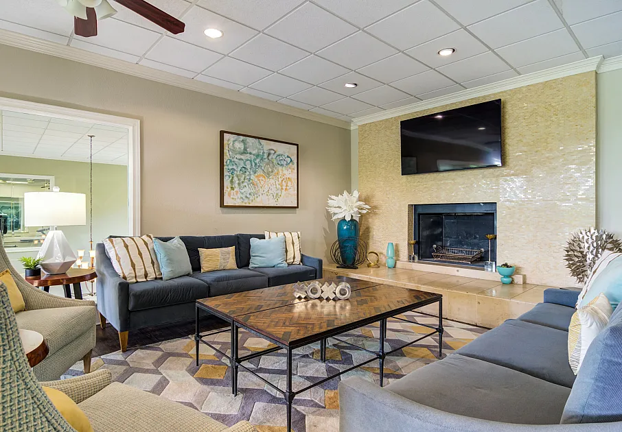 Community center seating area with fireplace and TV