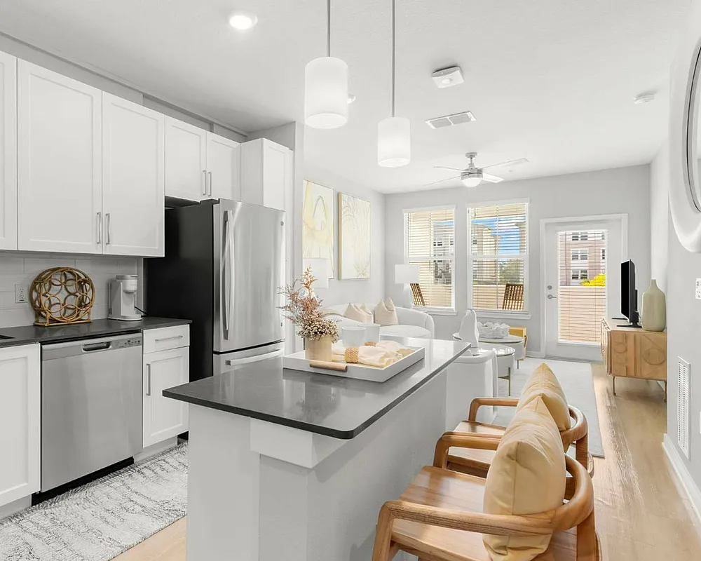 Photo of kitchen open to living room with modern decor and furniture