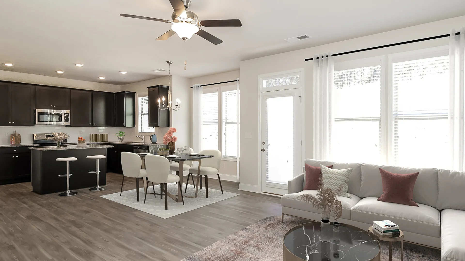 living room looking into kitchen with brown cabinets