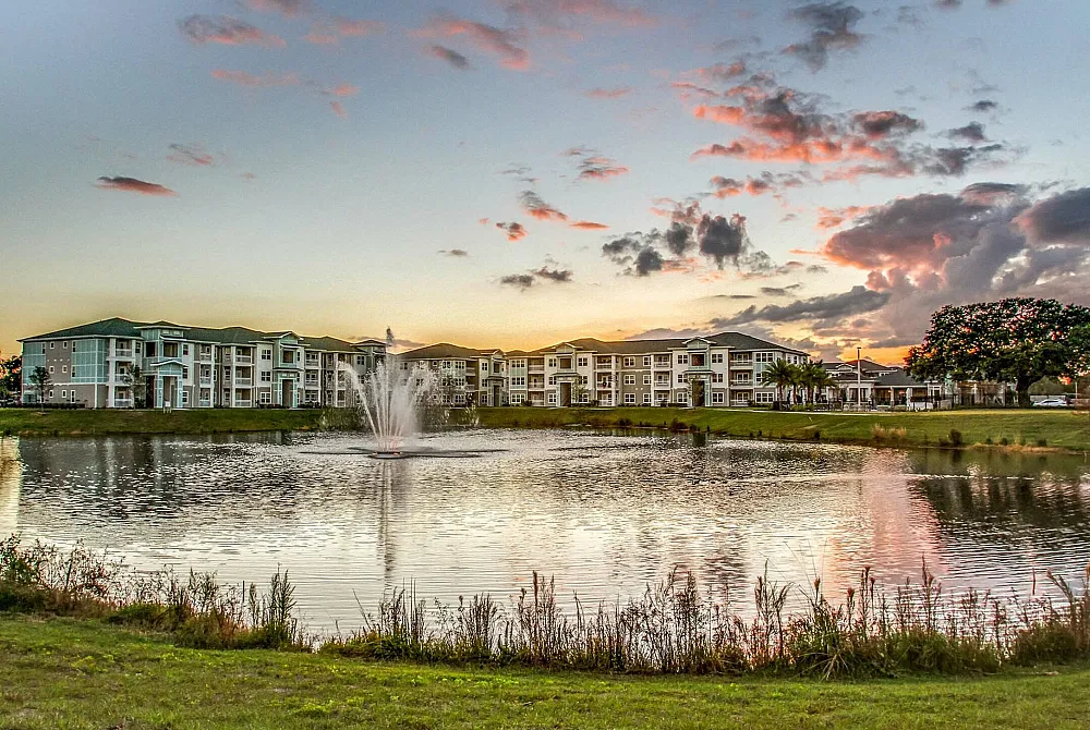 The exterior of The Sands at Clearwater Apartments in Clearwater, FL, featuring a water feature with a fountain.