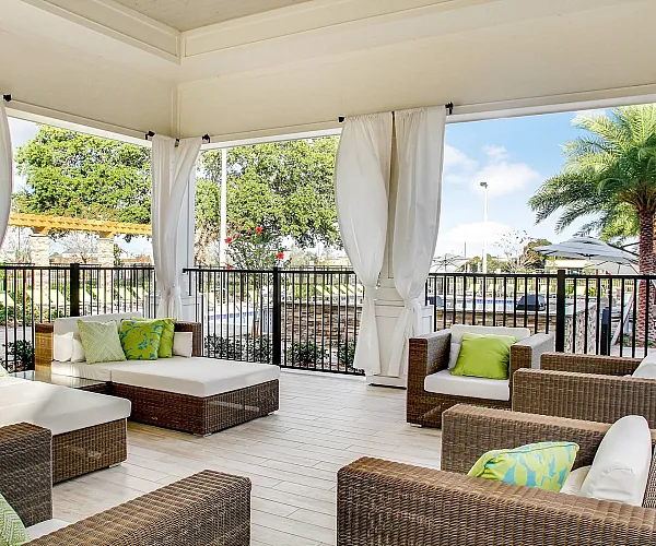 The outdoor lounge at The Sands at Clearwater Apartments in Clearwater, FL, featuring cushioned seating.
