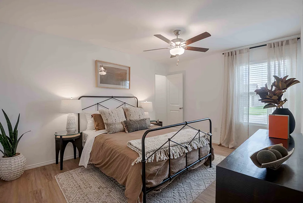 model bedroom with tan duvet