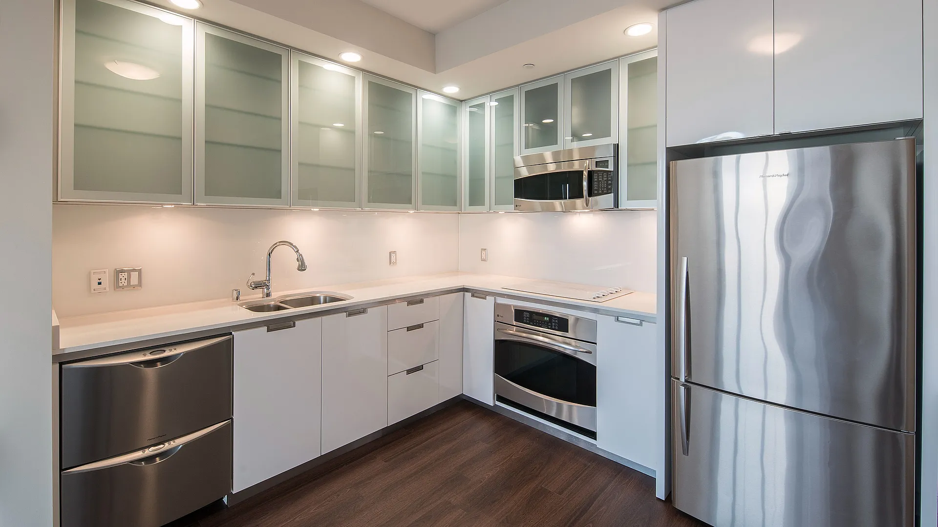 Sleek modern kitchen with stainless steel appliances, elegant cabinetry, and contemporary lighting.