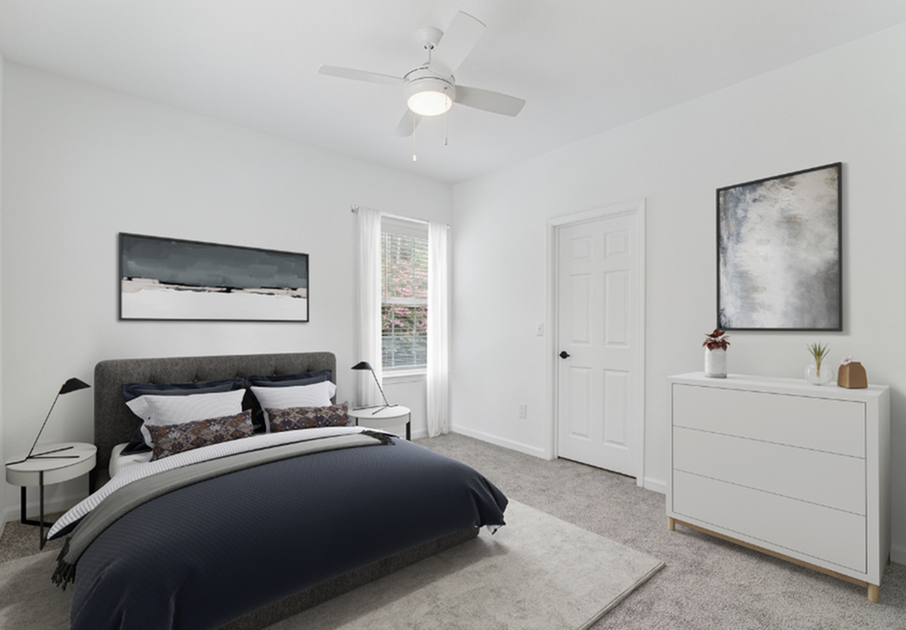 Elegant bedroom showcasing a stylish bed with cozy linens, chic nightstands with modern lamps, and a sleek dresser under ambient lighting.