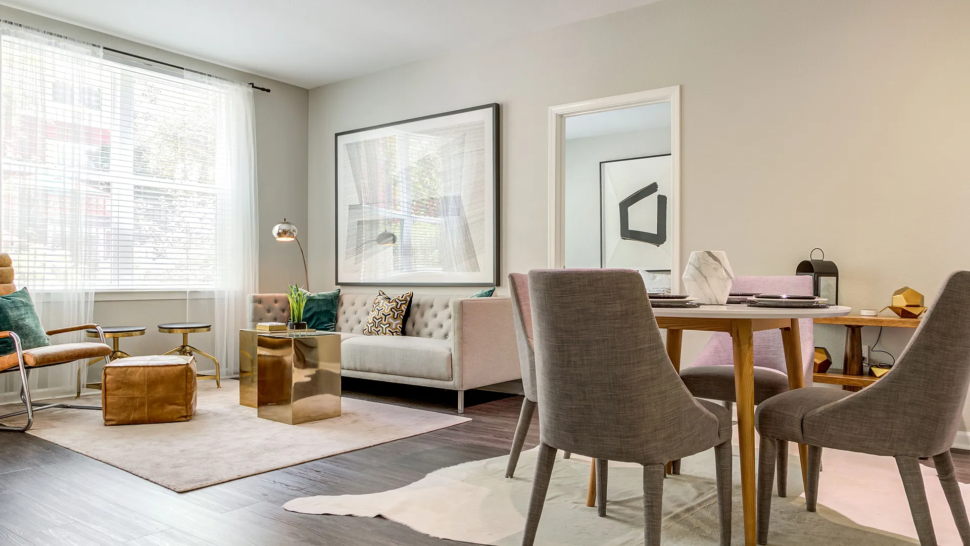 Chic and inviting living and dining area featuring modern furniture, stylish decor, and abundant natural light.