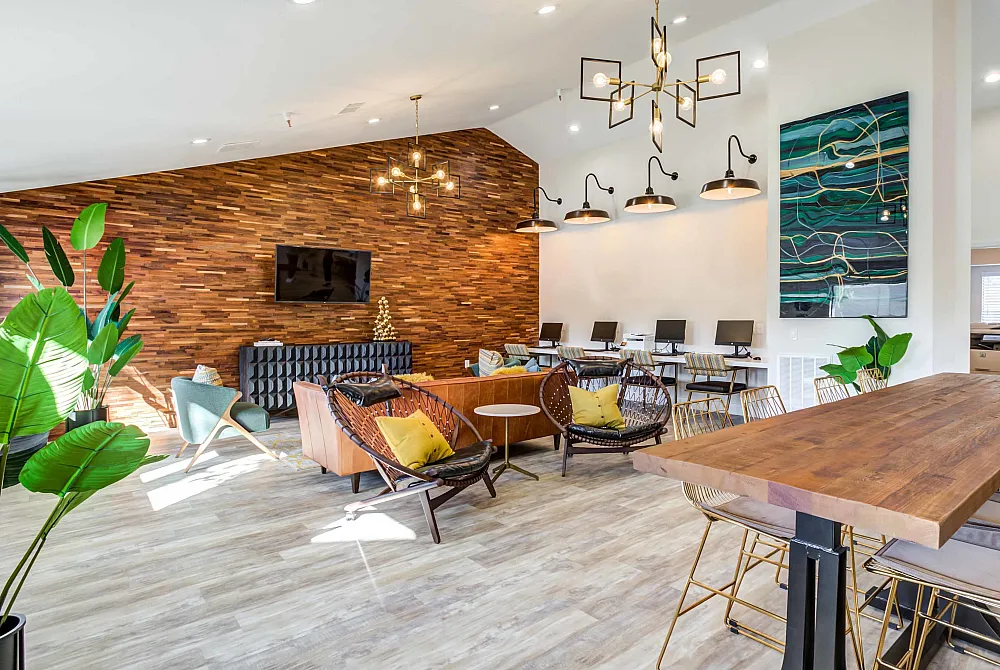 Chic and contemporary lounge space with stylish seating, a wooden accent wall, and modern lighting, perfect for relaxation and work.