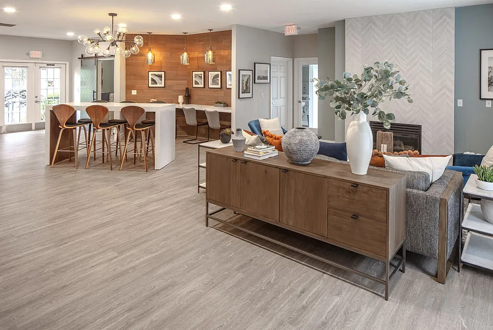 Elegant open-concept living space with modern kitchen, stylish pendant lights, and cozy seating area, perfect for entertaining.