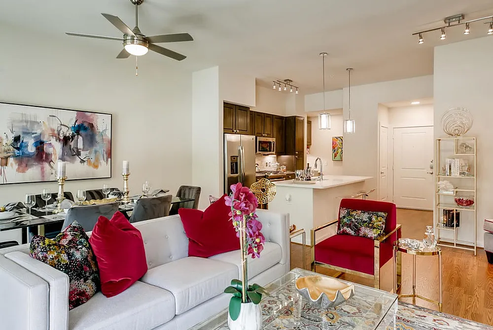 Chic open-concept living room with stylish decor, cozy seating, contemporary dining area, and sleek kitchen design.