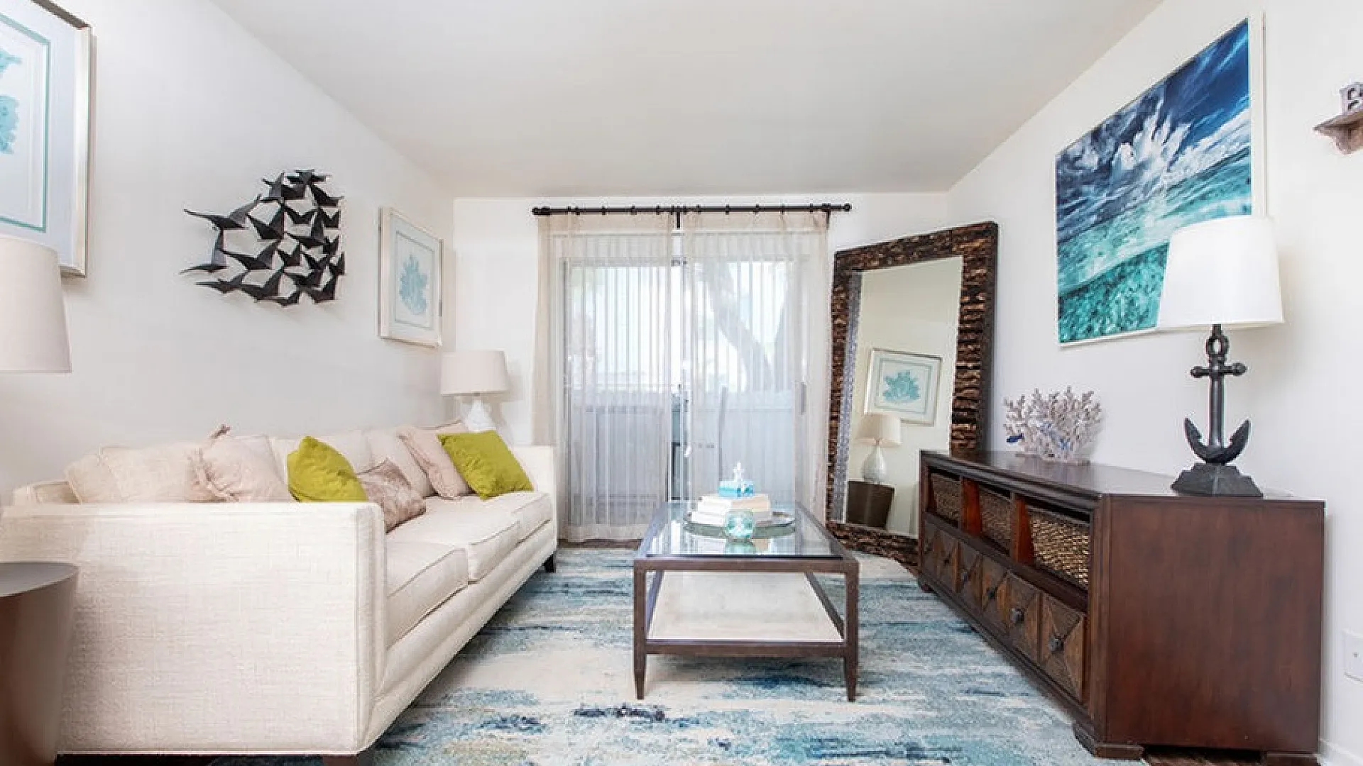 Chic living room with comfortable beige sofa, stylish decor, and large window offering natural light.