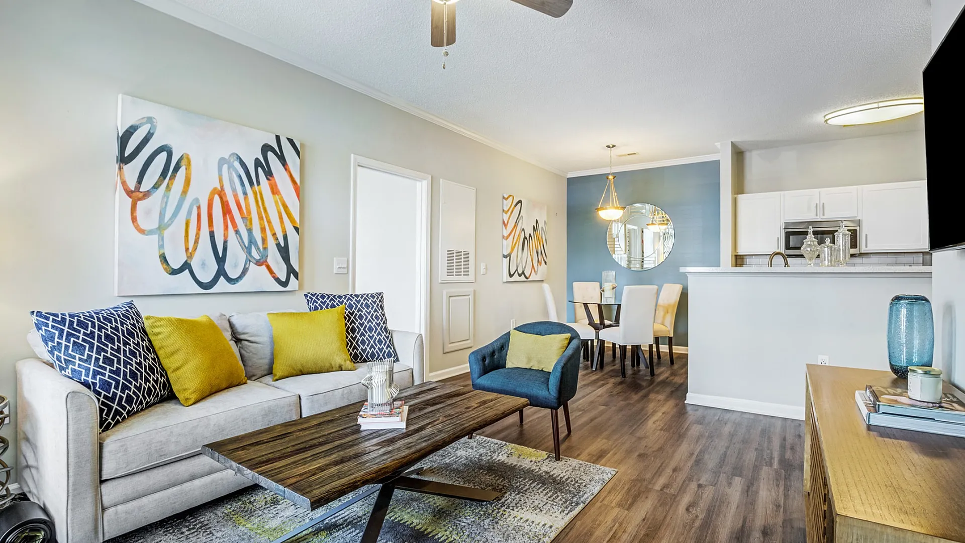 Bright and inviting living space featuring modern decor, comfortable seating, and an open dining area adjacent to a stylish kitchen.