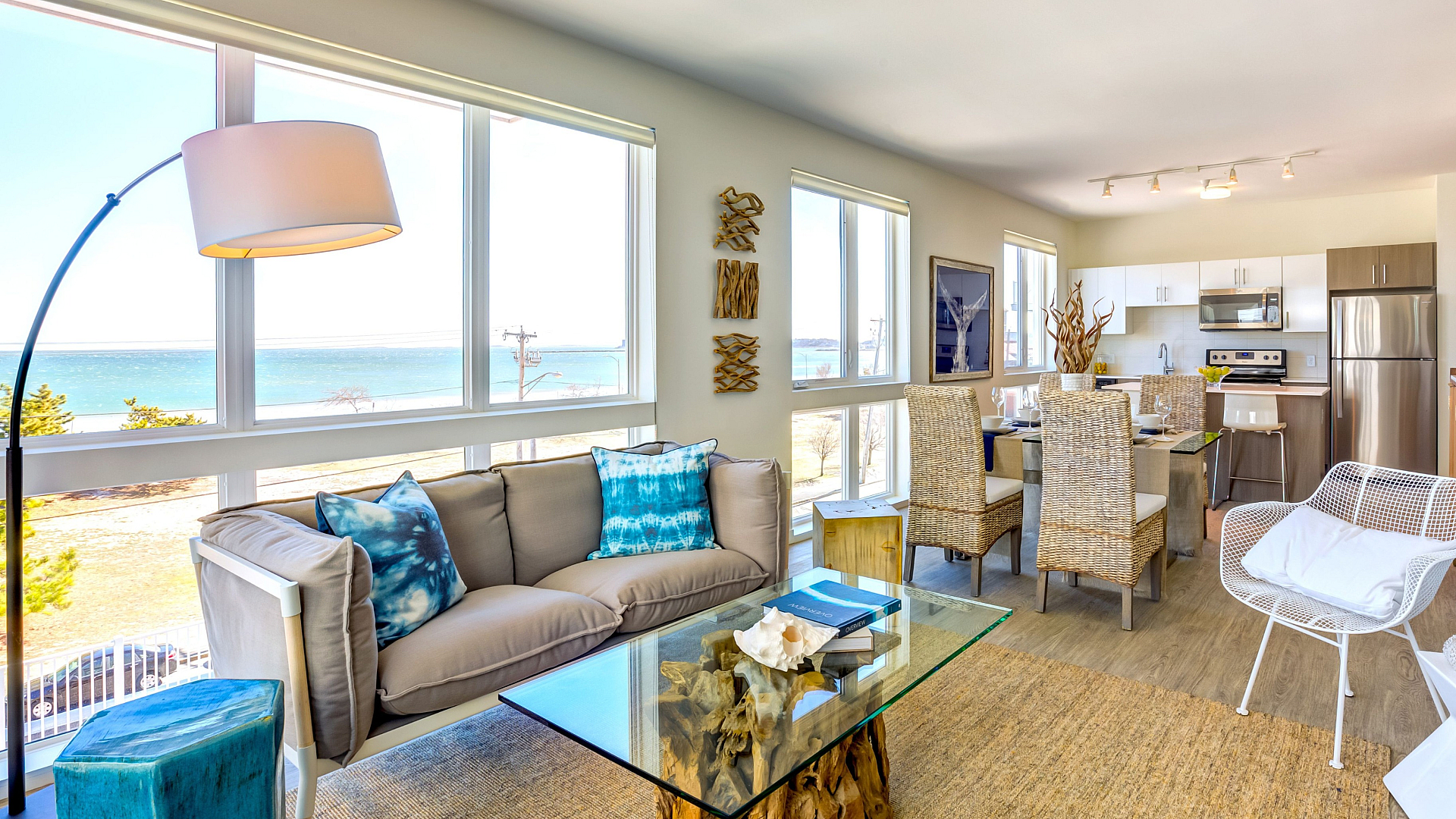 Bright, open-concept living space with ocean views, modern kitchen, chic dining area, and cozy seating, perfect for relaxation and entertaining.