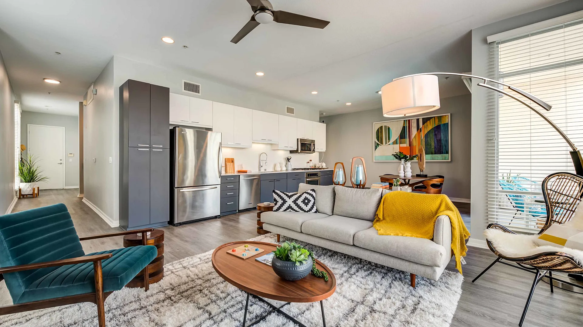 Chic open-concept living space with modern kitchen, stylish decor, and abundant natural light.