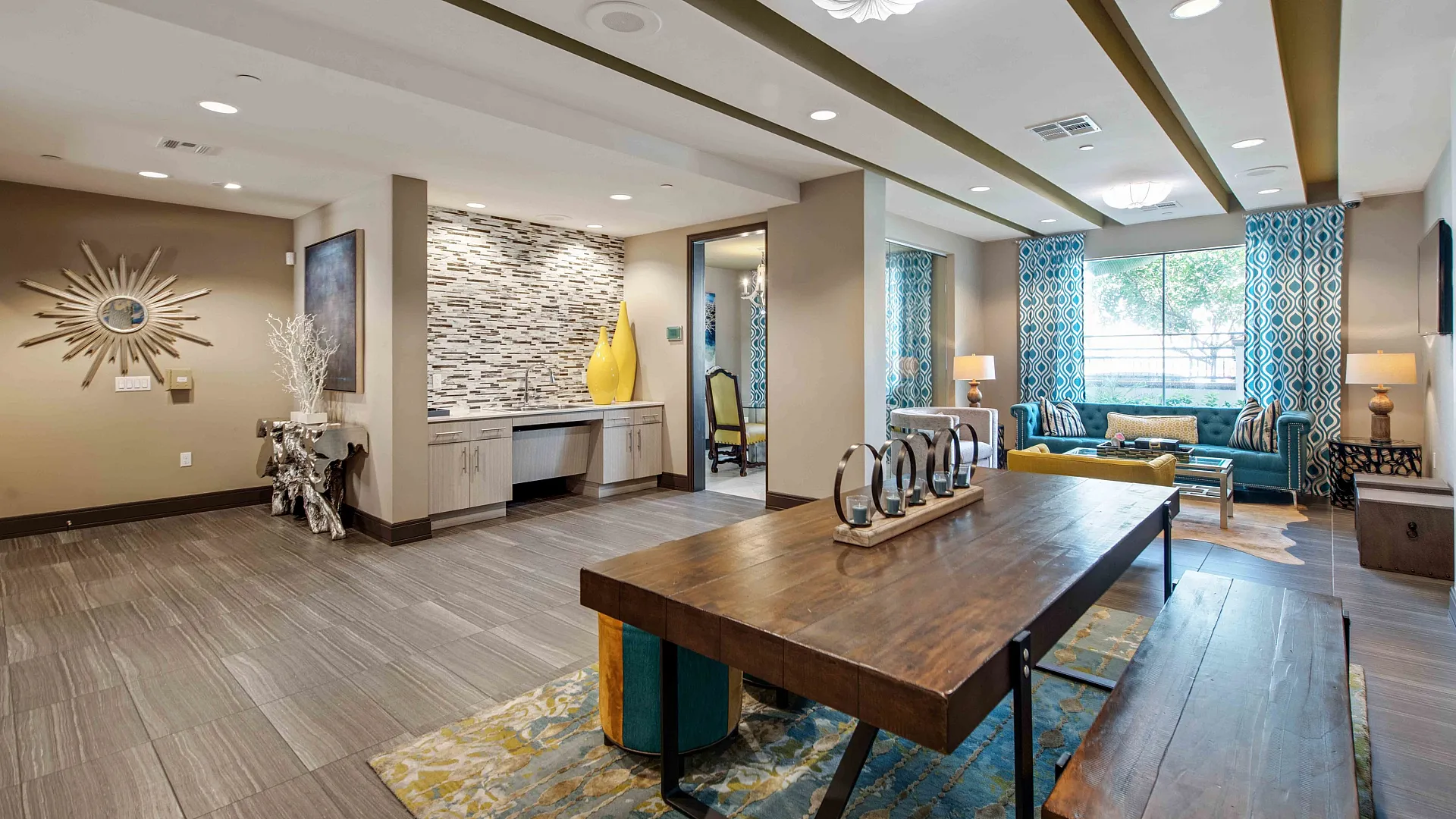 Elegant apartment lounge featuring modern decor, chic furniture, and bright natural light from large windows.