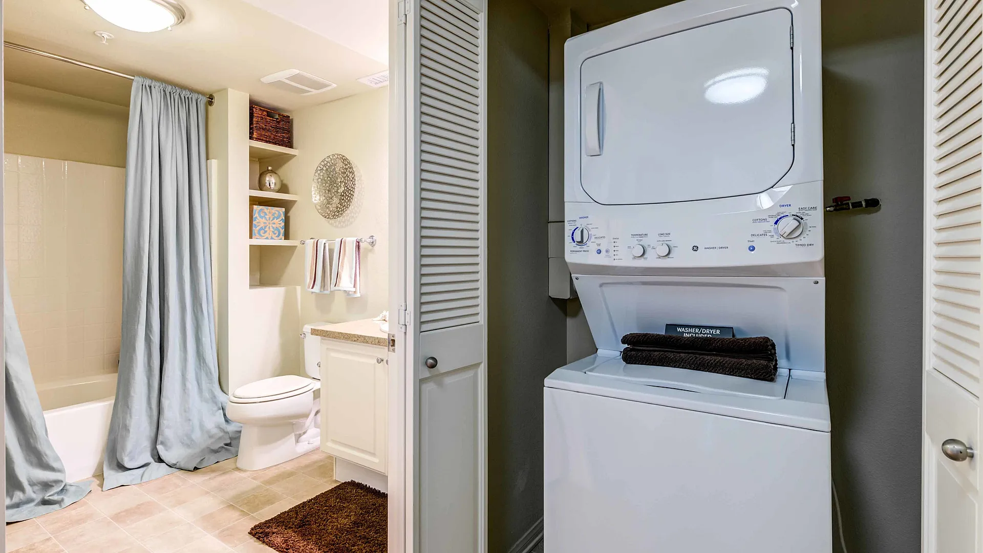 Chic bathroom and laundry area with modern washing machine, elegant vanity, and cozy bath essentials.