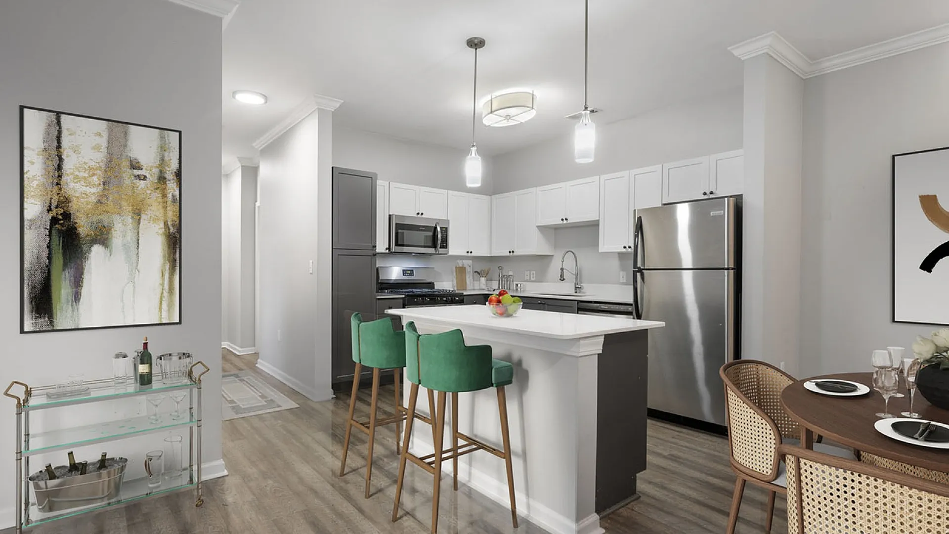 Elegant modern kitchen with stainless steel appliances, chic pendant lighting, green bar stools at a white island, and stylish artwork.