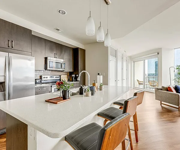 Luxurious rooftop pool with comfortable lounge chairs, featuring stunning city views and modern high-rise architecture.