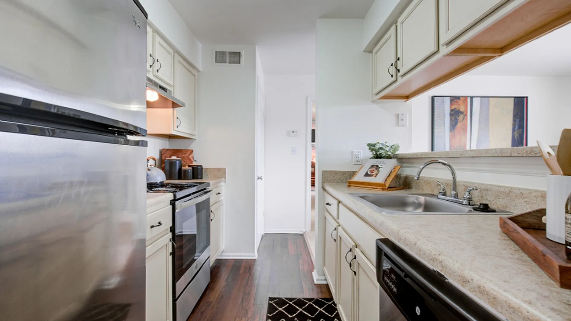 Bright and modern kitchen with stainless steel appliances, sleek countertops, and ample cabinetry space, perfect for culinary creativity.