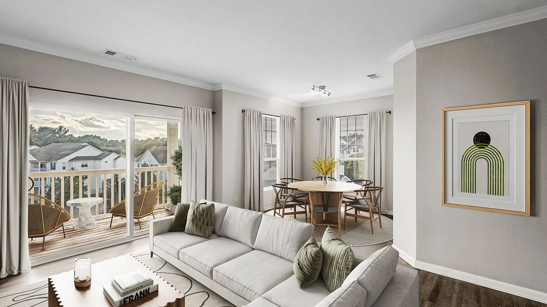 Elegantly designed living space with a cozy modern sofa, artful coffee table, and bright dining area leading to a scenic balcony view.
