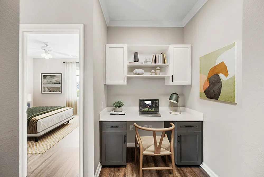 Modern home office nook with elegant desk setup adjacent to a cozy bedroom featuring natural lighting and stylish decor.