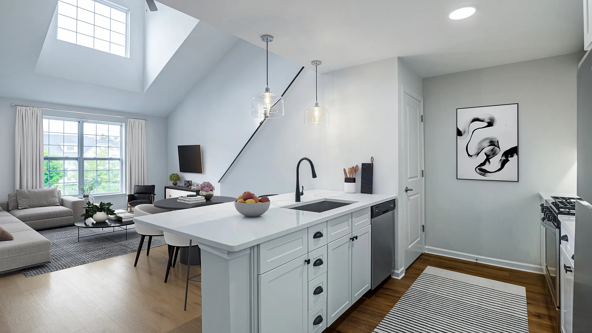 Modern open-concept living room and kitchen with high ceilings, sleek white cabinets, and large windows offering ample natural light.